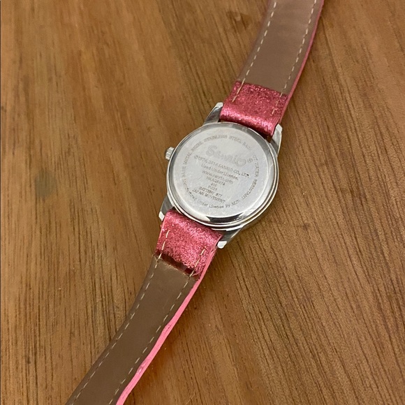 This is a Hello Kitty analog watch with a sparkly pink band and a jeweled bow - Picture 6 of 7